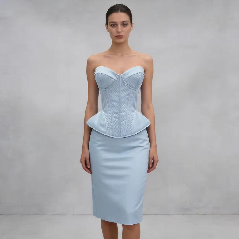 Model wearing a structured, light blue luxury corset bustier with a peplum waist and sweetheart neckline.