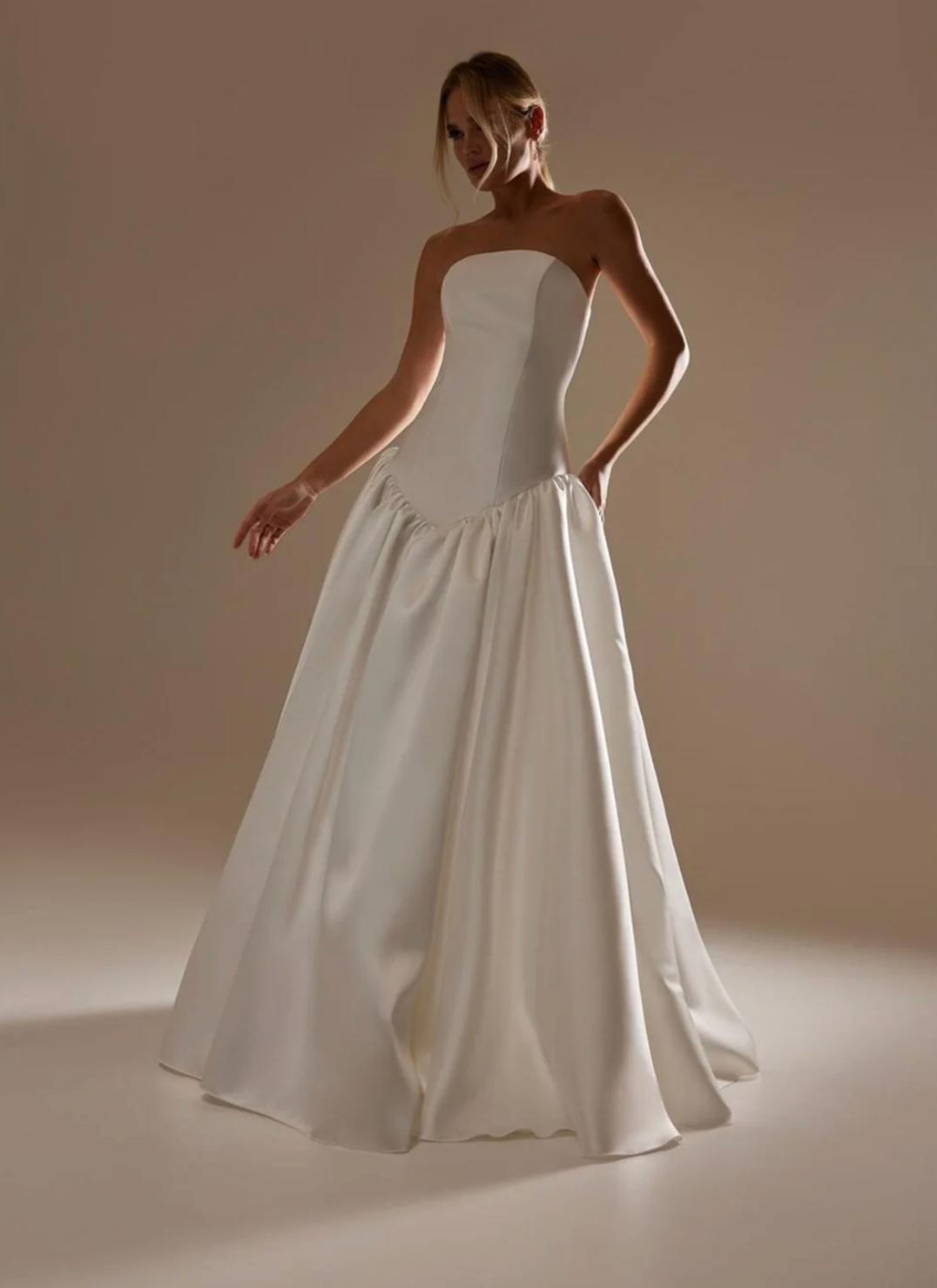 Strapless white satin A-line evening gown with a fitted bodice and floor-length skirt for formal events.