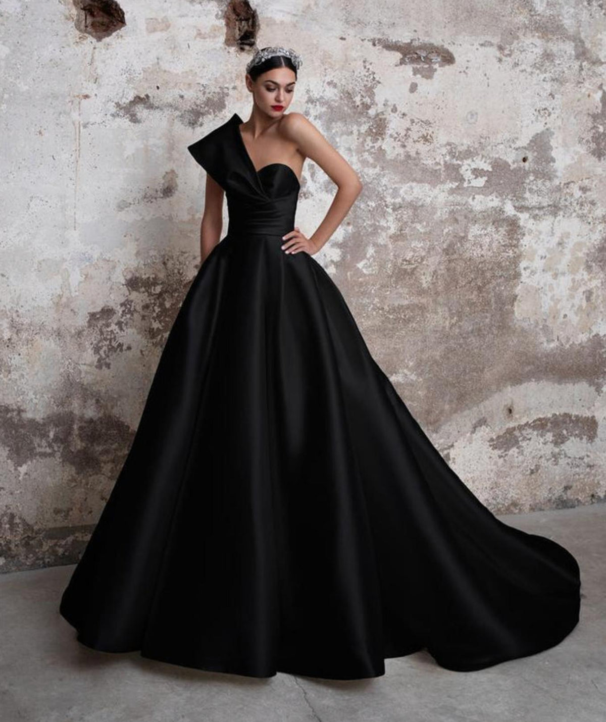 Black Mikado satin ball gown with an asymmetrical off-shoulder neckline and a dramatic full skirt for formal events.