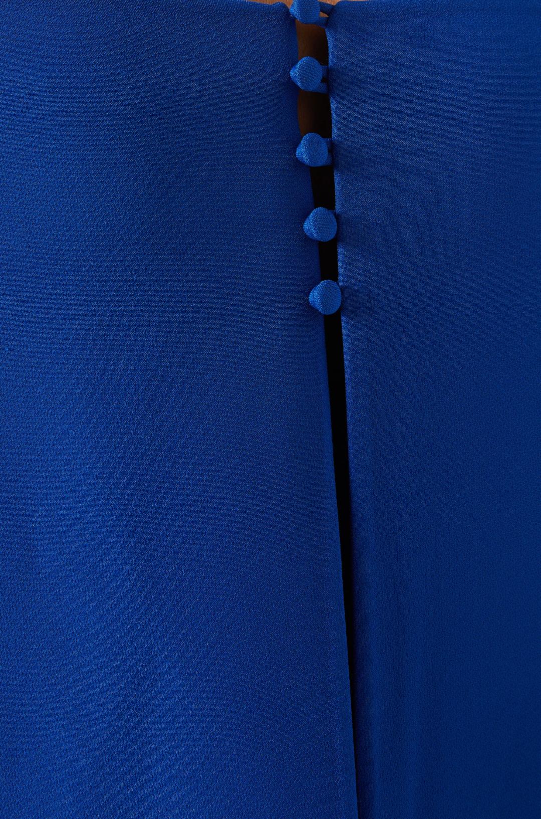 Close-up of a royal blue polyester dress featuring a vertical row of matching fabric-covered buttons.