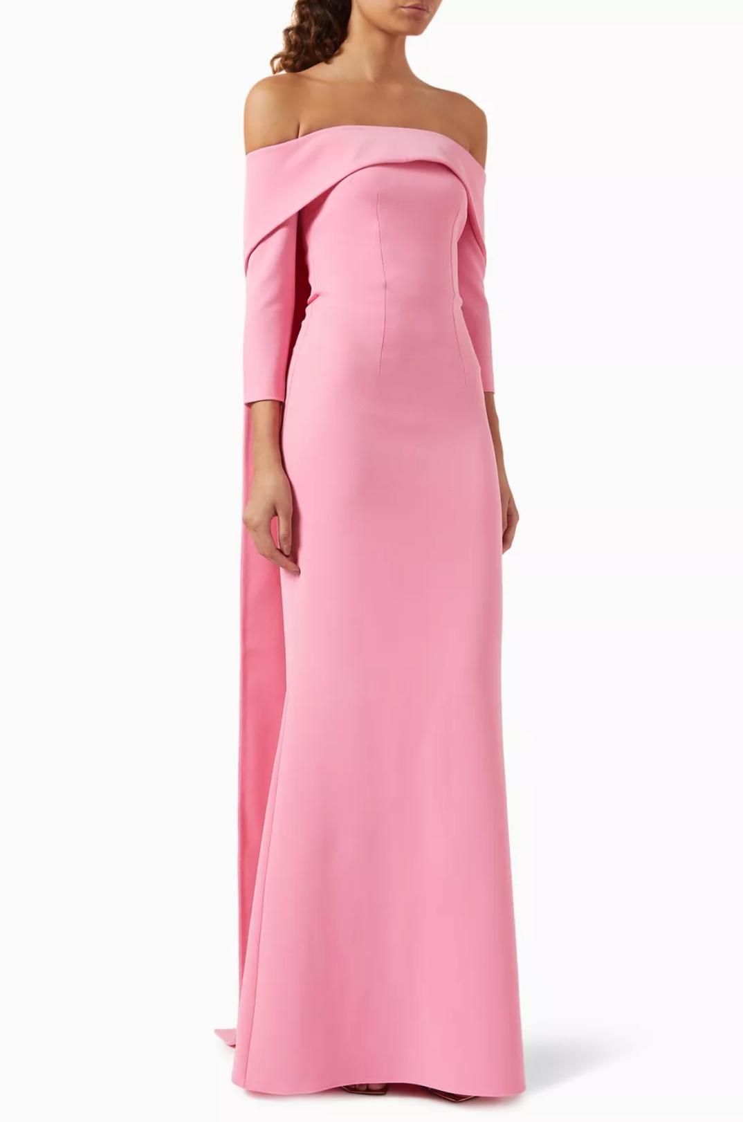 Pink off-the-shoulder floor-length gown with long sleeves and a flowing train in smooth polyester jersey.