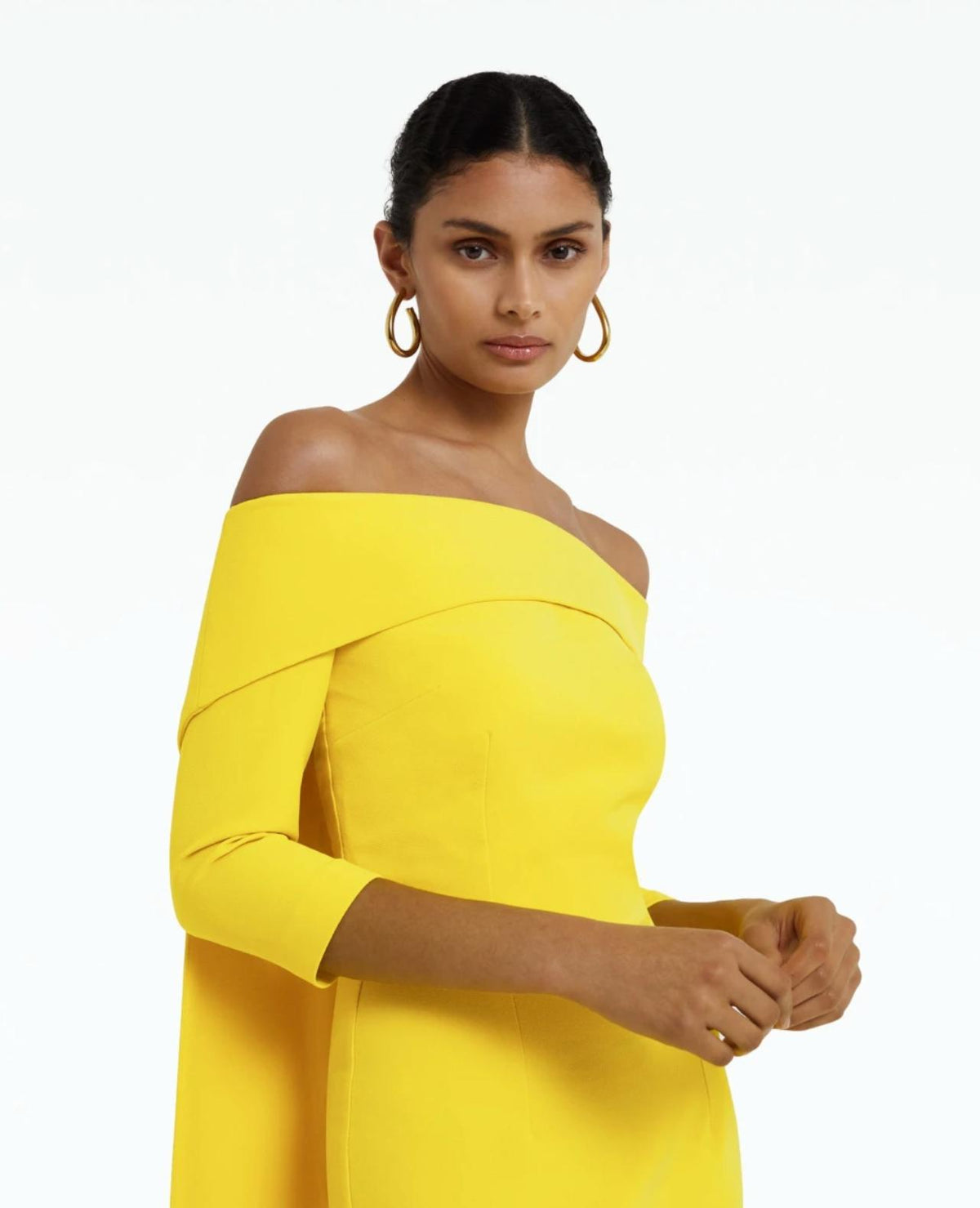 Model wearing a bright yellow off-the-shoulder polyester dress with three-quarter sleeves and a fitted silhouette.
