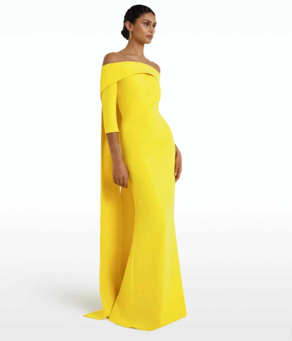 Bright yellow off-the-shoulder floor-length gown with a train and fitted silhouette in smooth jersey fabric.