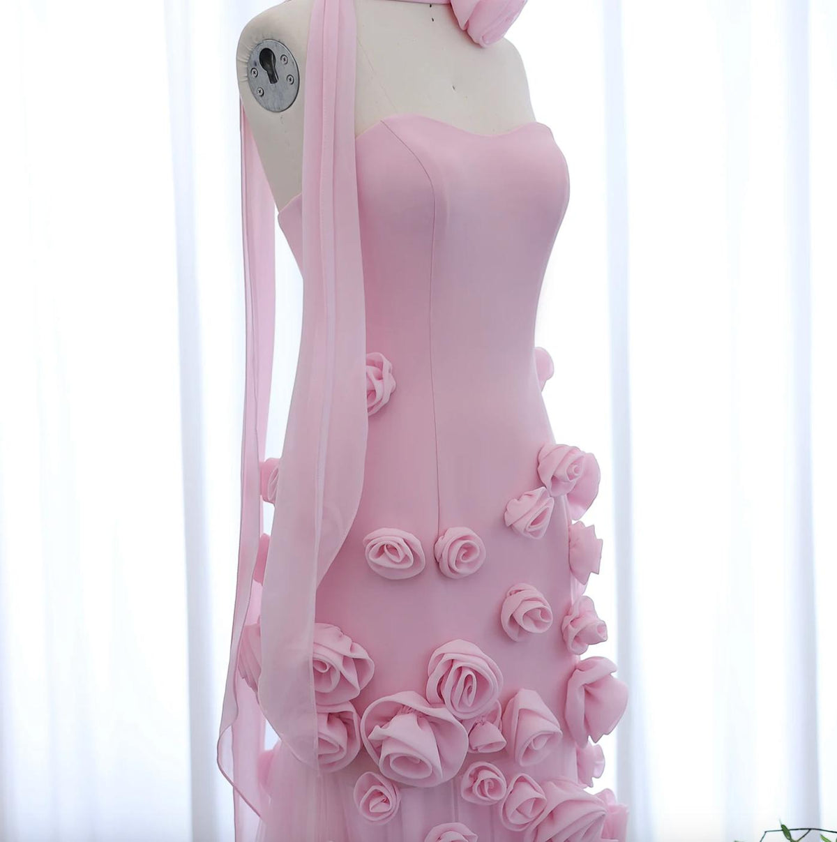 Pink Evelyn Walk trumpet gown featuring a sweetheart neckline and intricate 3D floral appliqués on soft tulle fabric.