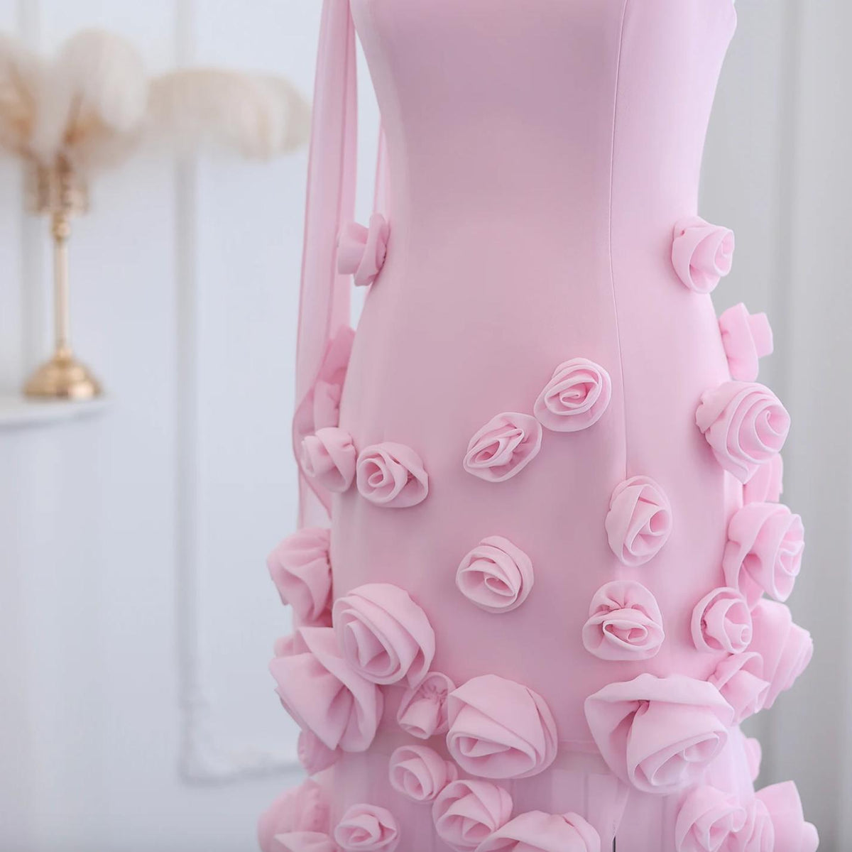Light pink trumpet gown featuring a sweetheart neckline and intricate 3D floral rose appliqués on soft tulle fabric.