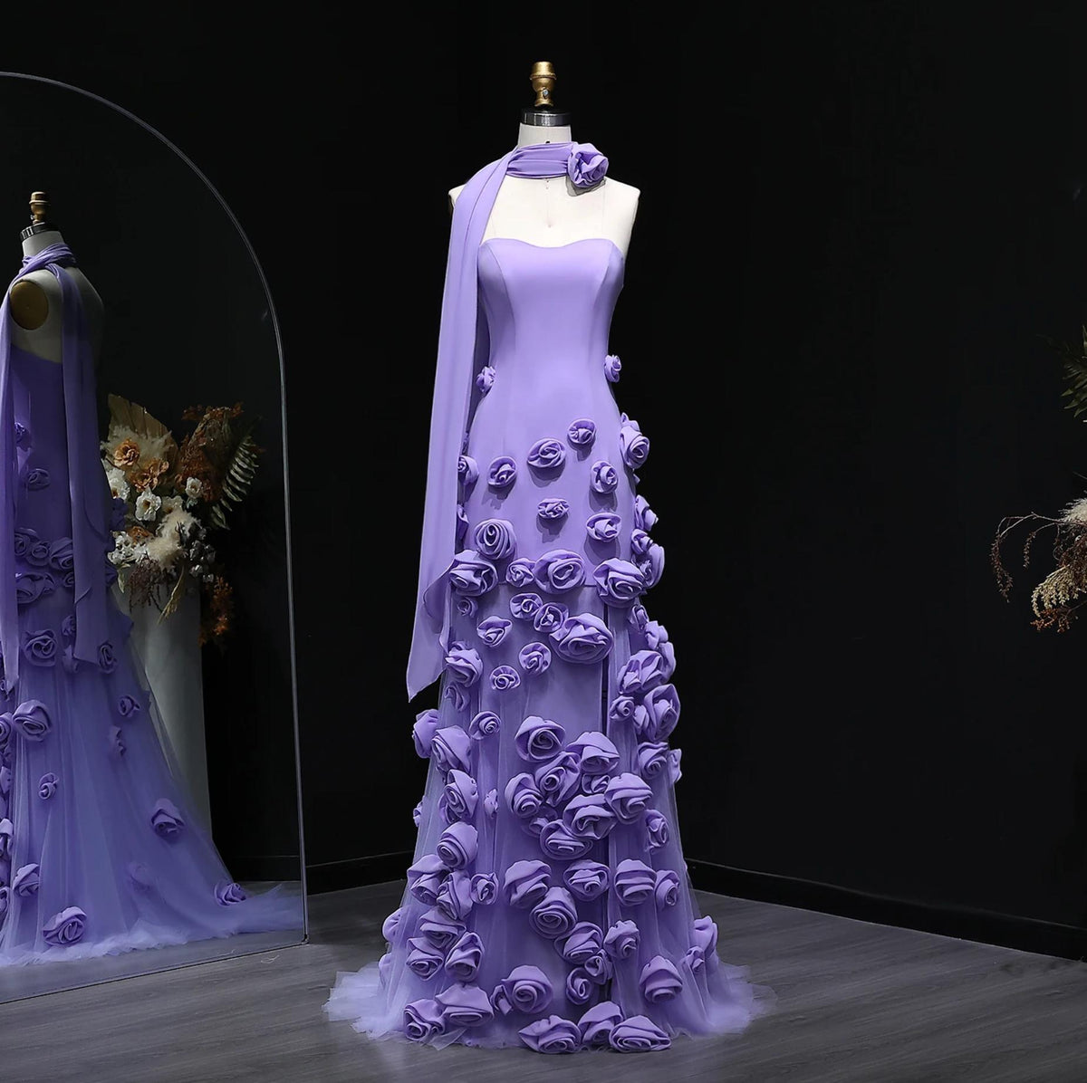 Lavender trumpet gown with sweetheart neckline, 3D floral appliqués, and a matching tulle scarf on a mannequin.