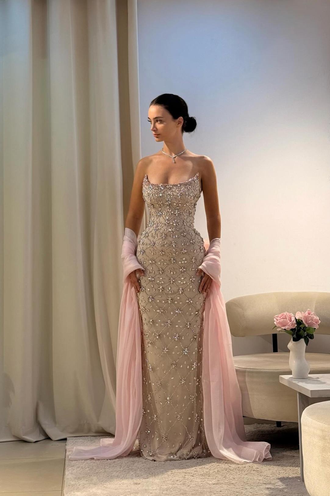 Beaded champagne evening gown with scoop neckline and flowing pink shawl, perfect for formal galas and celebrations.