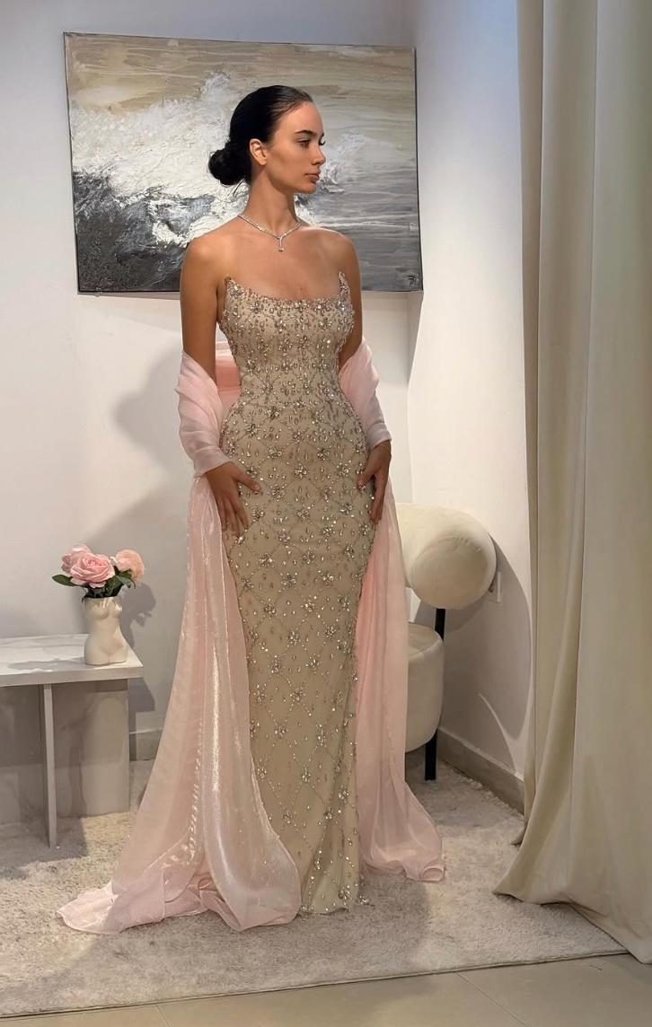 Beige sleeveless evening gown with heavy crystal beading, scoop neckline, and a flowing light pink coordinating shawl.