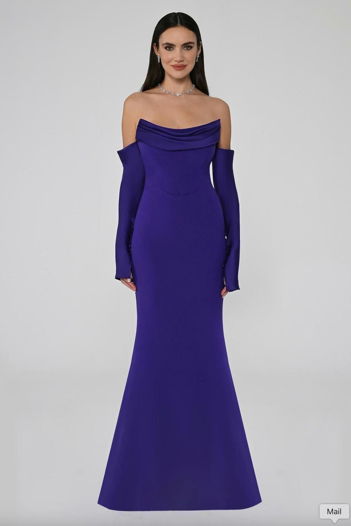 Royal purple strapless mermaid evening gown with pleated bodice, long sleeves, and button accents in satin fabric.