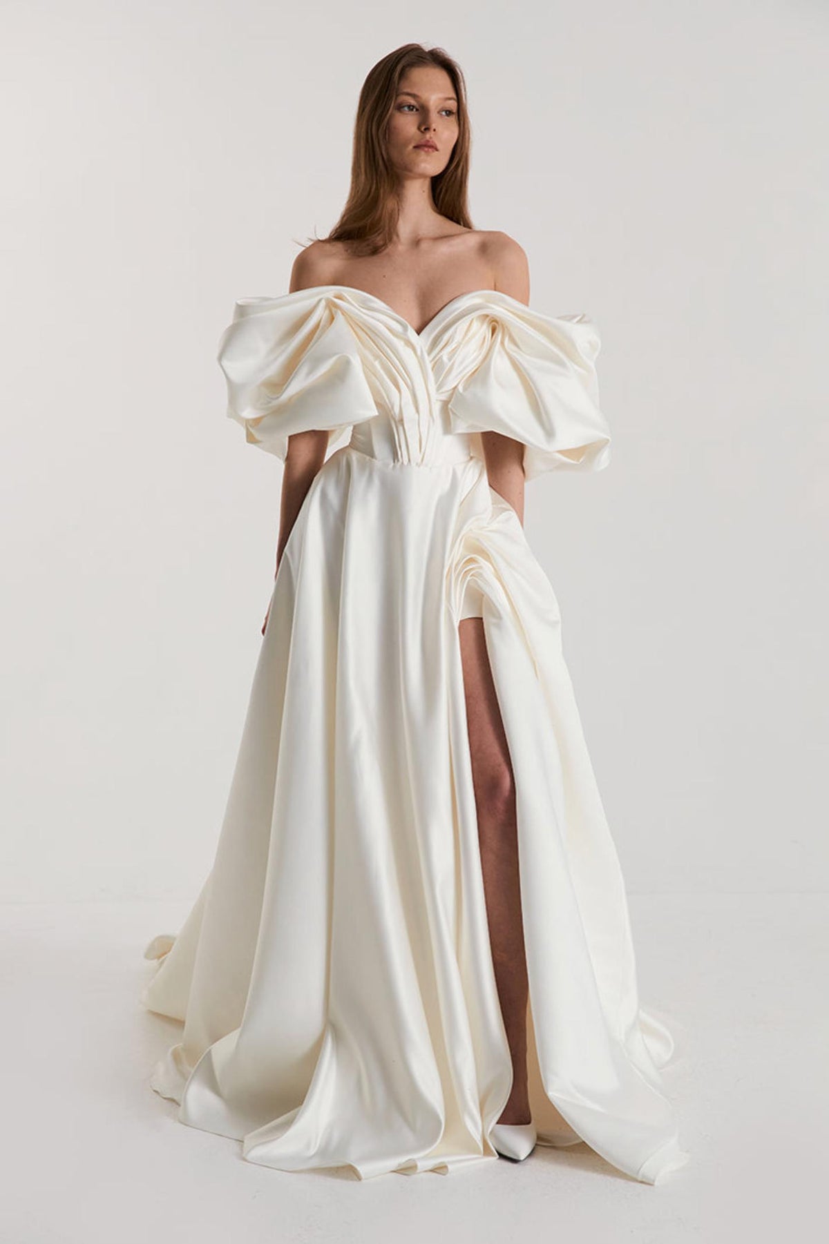 Off-shoulder white satin A-line gown with dramatic pleated sleeves and a high side slit for a formal vintage look.