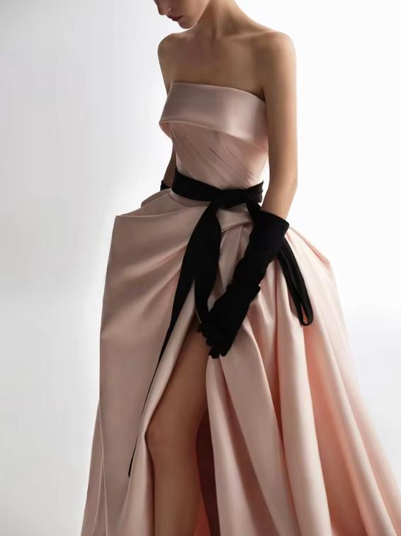 Strapless blush pink satin A-line ball gown with a side slit, black ribbon waist tie, and matching black opera gloves.