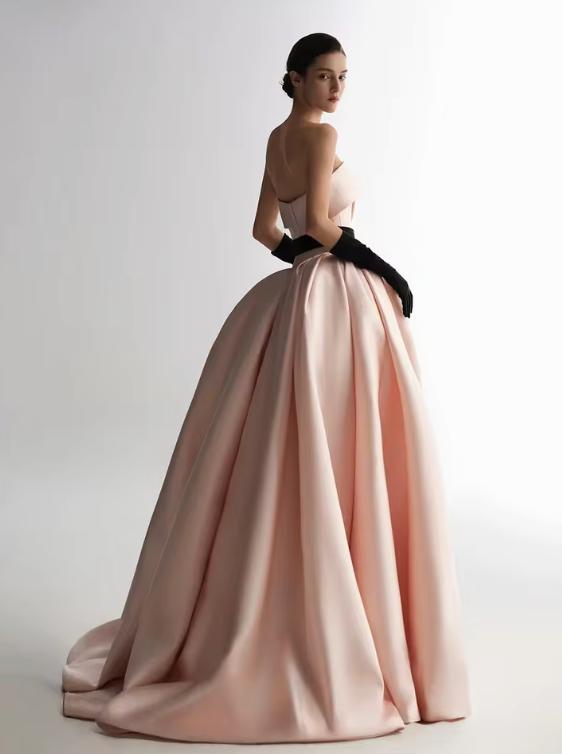Strapless pink satin A-line ball gown with a black waist ribbon and matching opera gloves.