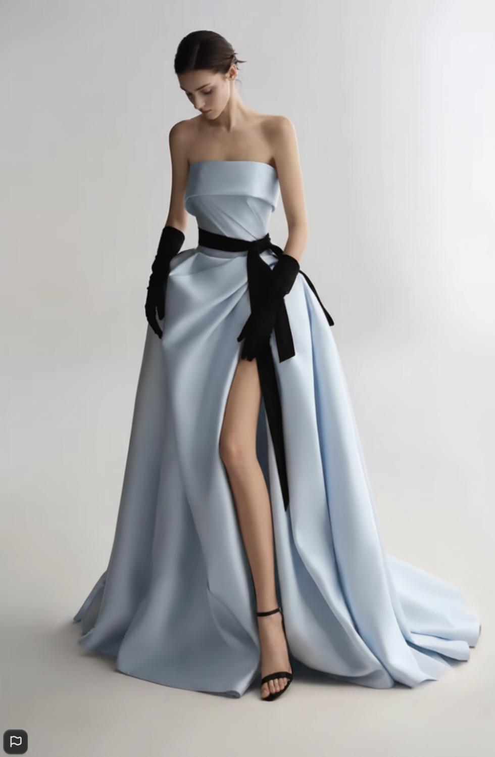 Strapless light blue satin A-line ball gown with a side slit, black ribbon waist detail, and matching opera gloves.