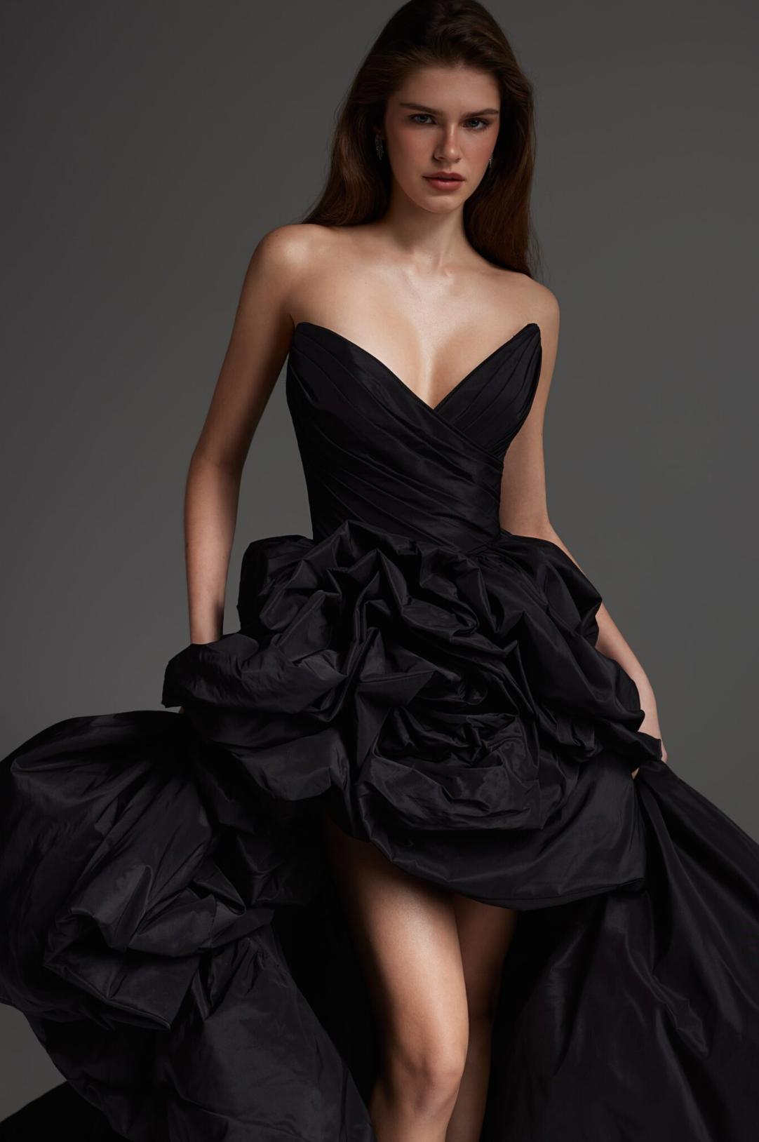 Elegant black taffeta strapless maxi gown featuring a structured bodice and voluminous ruffled skirt detailing.