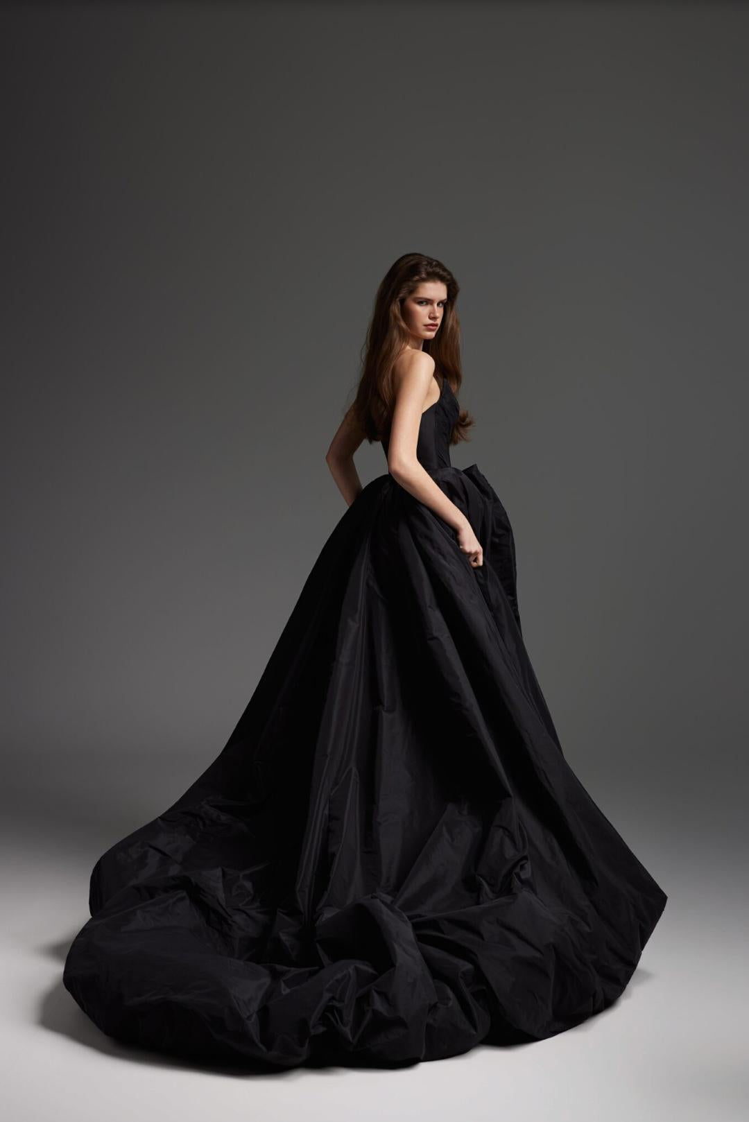 Elegant black taffeta maxi gown with a structured, voluminous skirt and ruffled detailing for a formal evening look.
