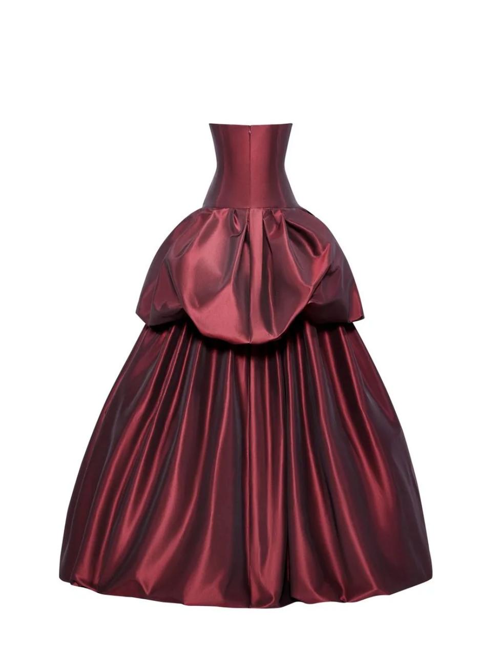 Strapless burgundy silk taffeta ball gown with a structured corset bodice and dramatic drop-waist tiered skirt.