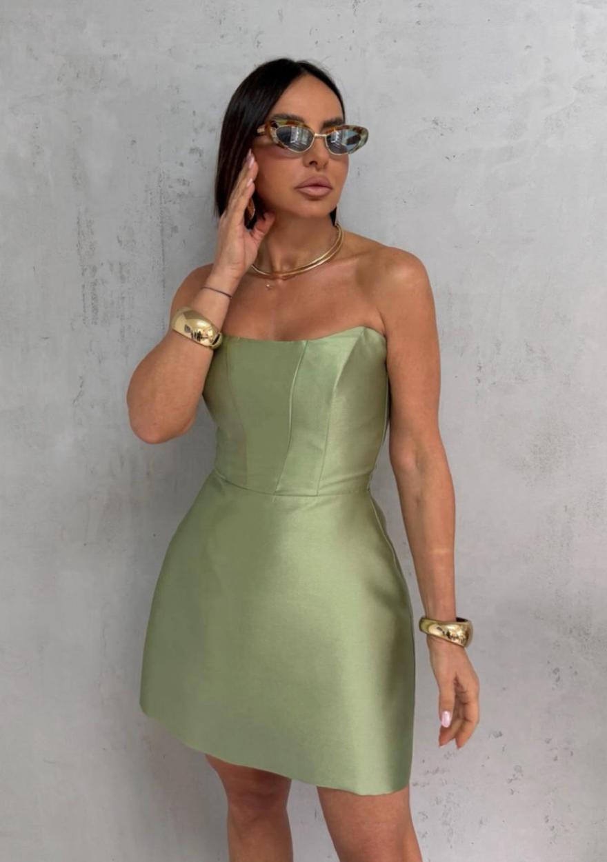 Sage green satin strapless mini dress with architectural seams and a sleek, polished silhouette.