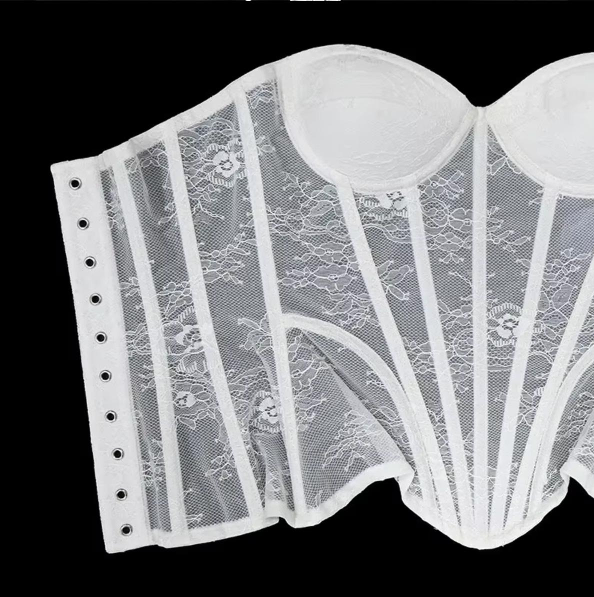 White lace corset bustier with steel-boned construction, mesh panels, and a structured sweetheart neckline.