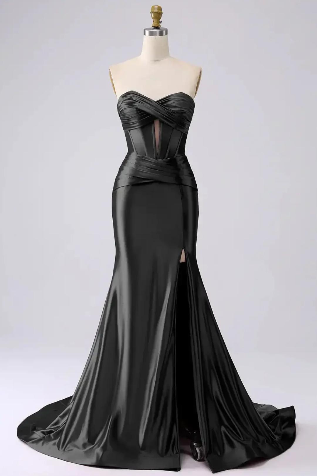 Black satin mermaid gown with a sweetheart corset bodice, pleated waist, and high leg slit on a mannequin.