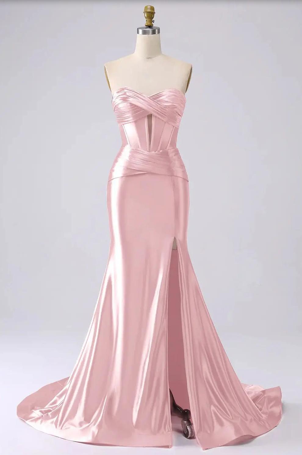 Pink satin mermaid gown with a sweetheart corset bodice, pleated details, and a high leg slit on a mannequin.