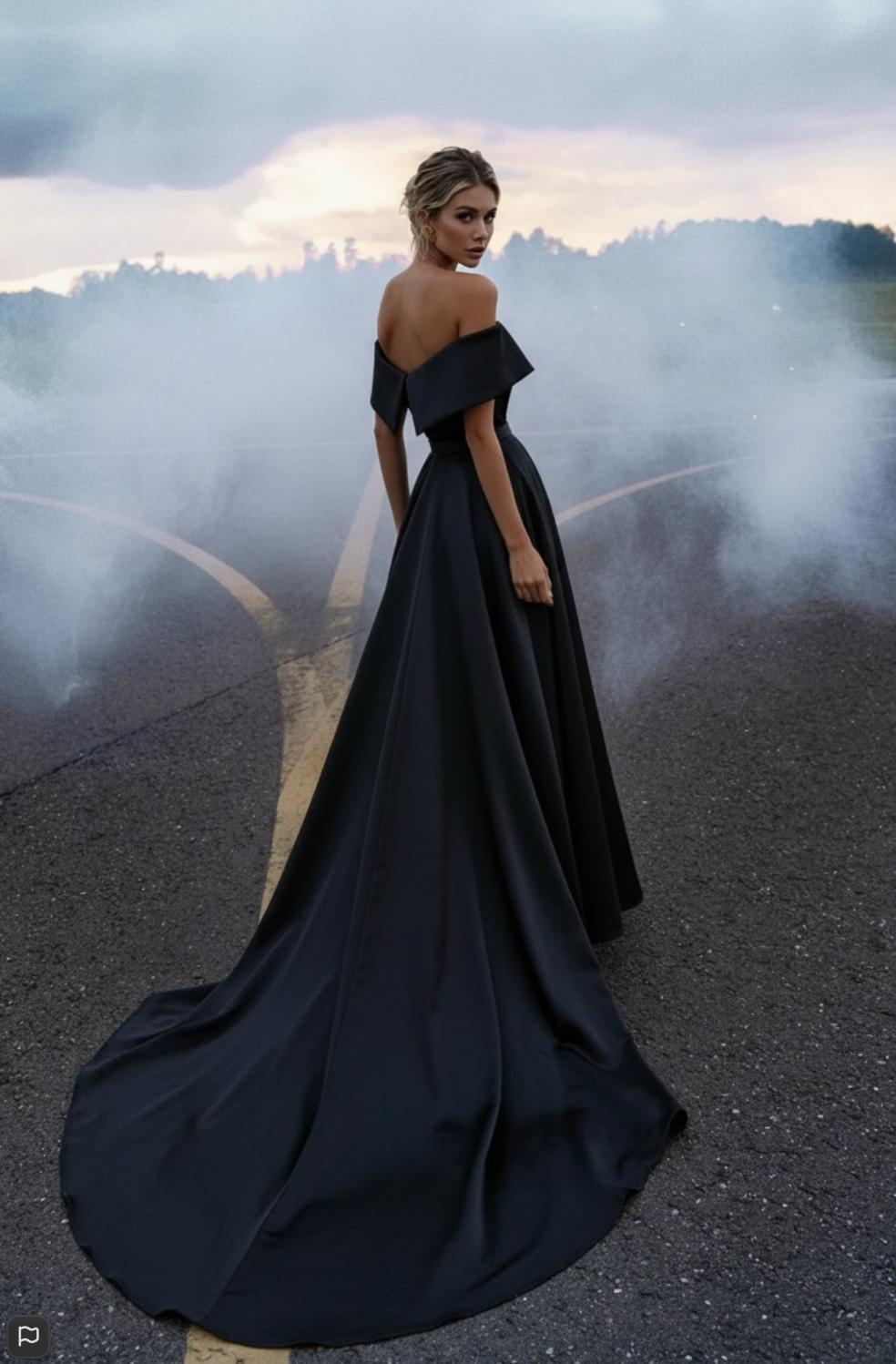 Black satin mermaid gown with off-shoulder sweetheart neckline and dramatic floor-length train on an outdoor runway.