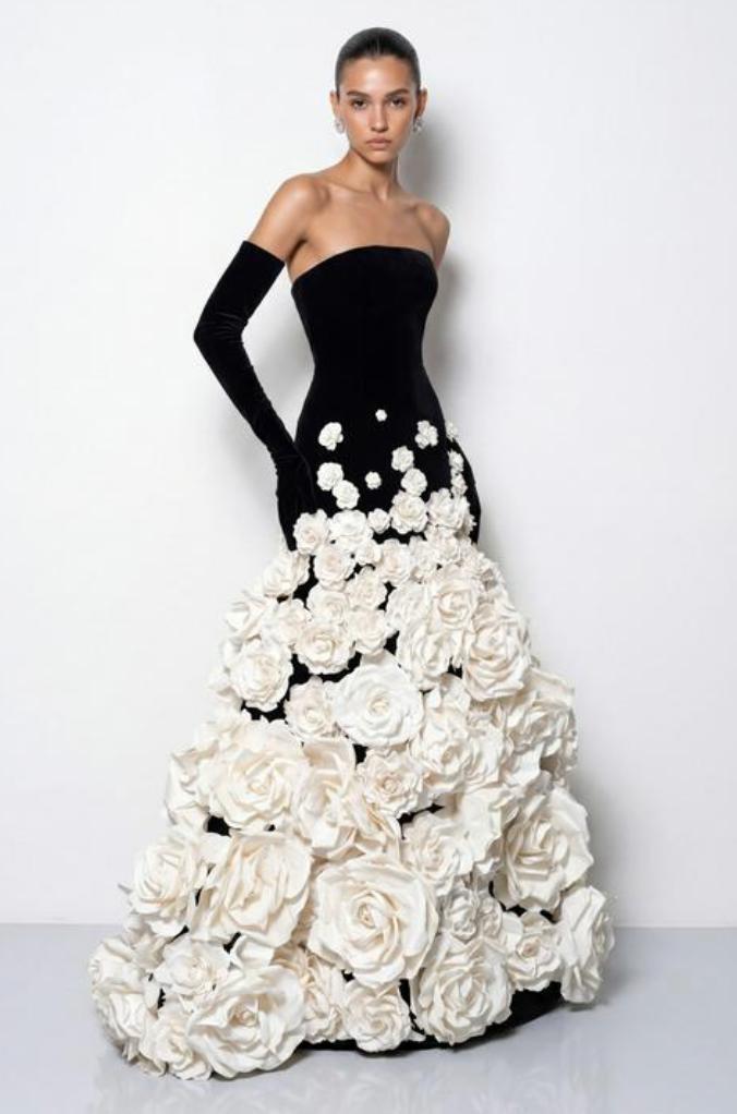 Strapless black velvet evening gown featuring a full skirt adorned with large white 3D floral embellishments.