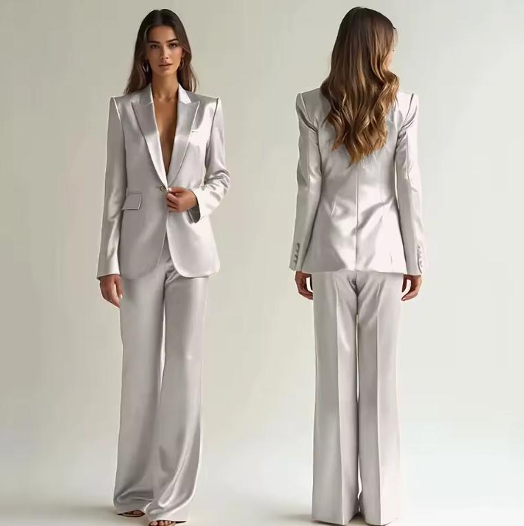 Model wearing a silver satin two-piece suit with a single-button blazer and wide-leg trousers, shown front and back.
