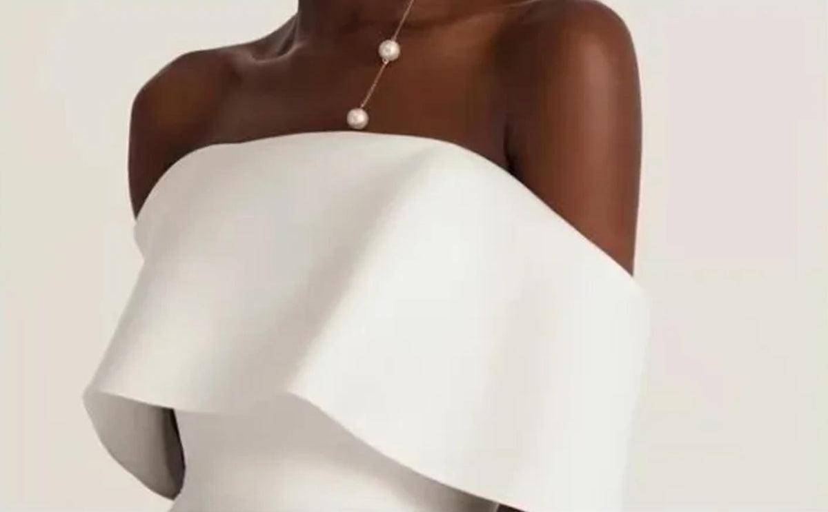 Elegant white off-shoulder Hvar gown in smooth satin with a structured boat neckline and minimalist design.
