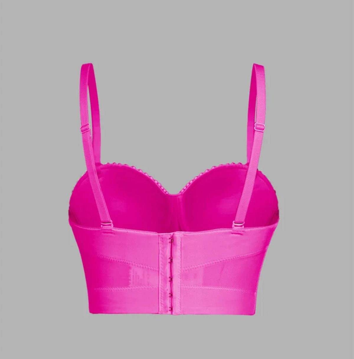 Back view of a bright pink handmade corset camisole with adjustable straps and a hook-and-eye back closure.
