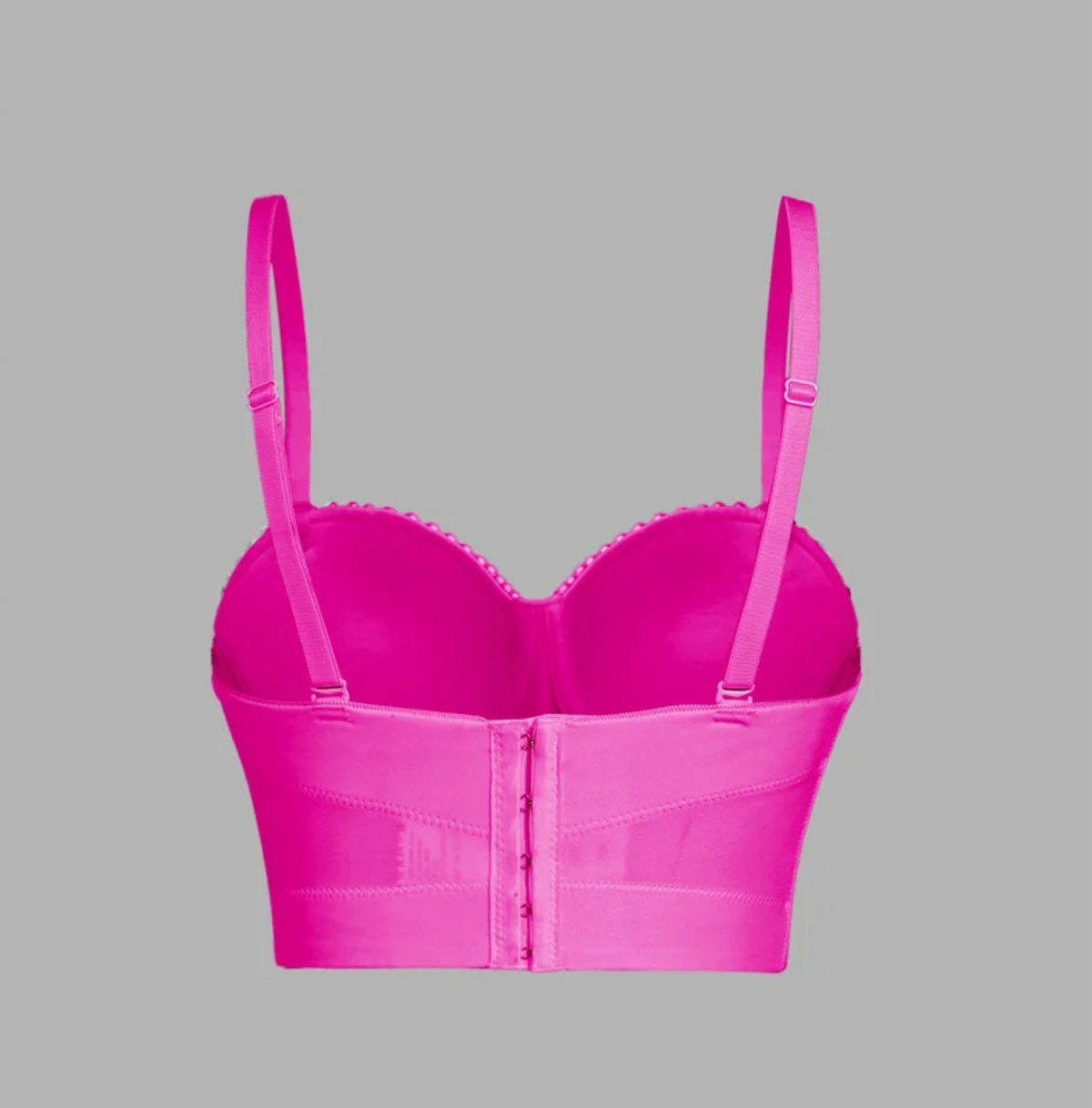 Back view of a bright pink handmade corset camisole with adjustable straps and a hook-and-eye back closure.