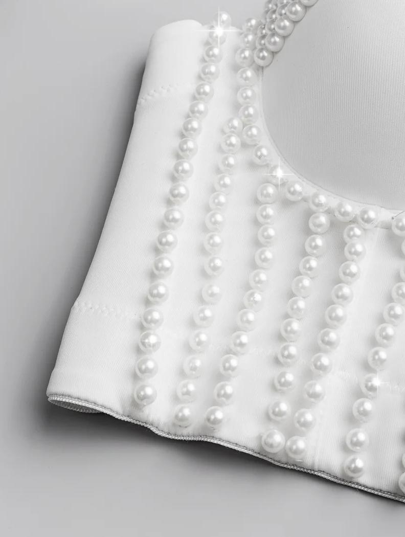 White handmade corset camisole featuring elegant vertical pearl bead embellishments on smooth polyester fabric.