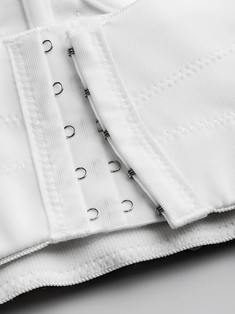 Close-up of a white Ina corset featuring a sturdy hook-and-eye closure system on premium polyester broadcloth fabric.