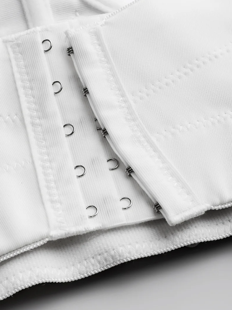 Close-up of a white Ina corset featuring a sturdy hook-and-eye closure system on premium polyester broadcloth fabric.