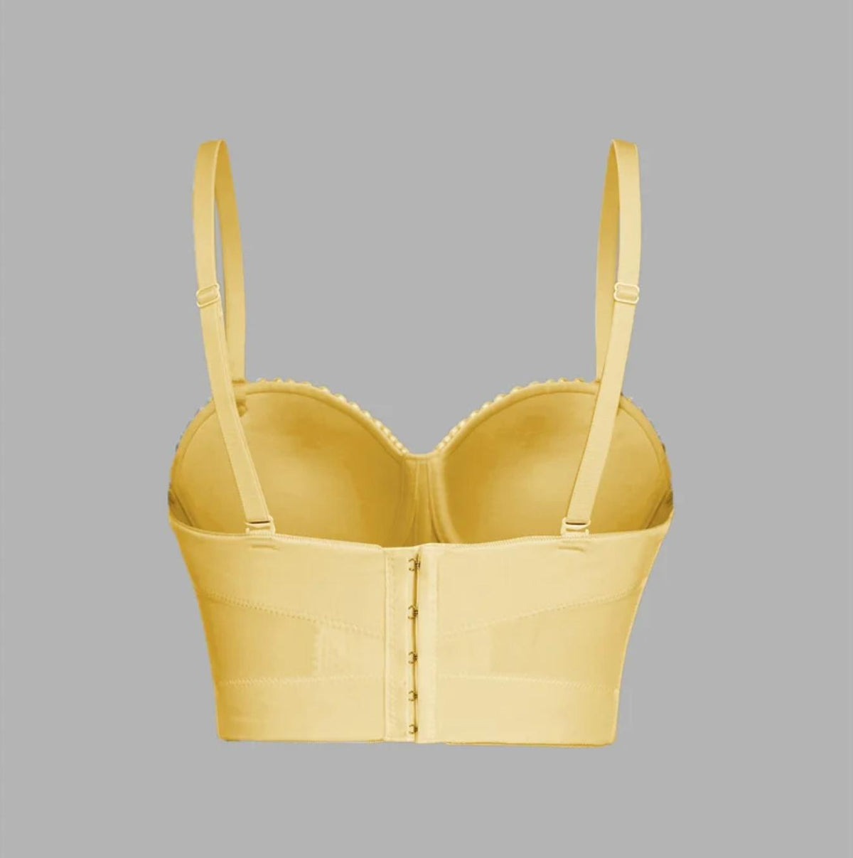 Back view of a yellow handmade Ina corset camisole with adjustable straps and a hook-and-eye back closure.