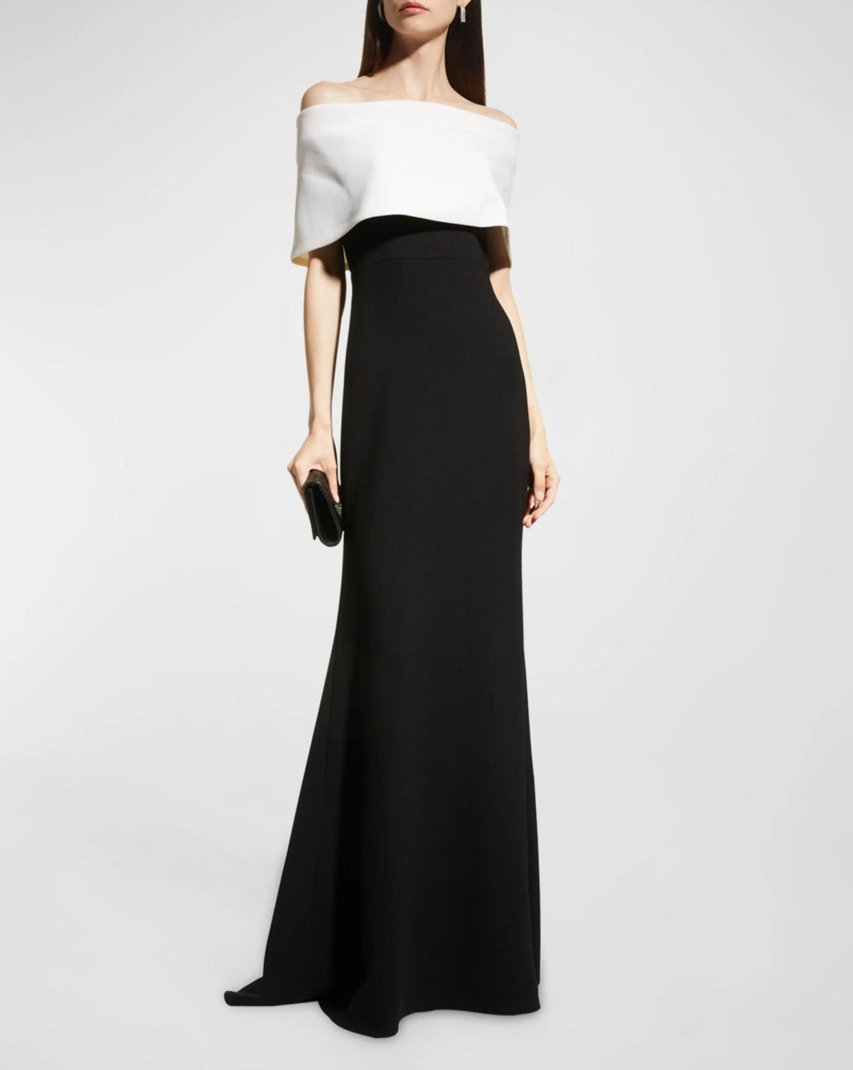 Two-tone off-the-shoulder crepe gown with a white fold-over bodice and floor-length black mermaid skirt.