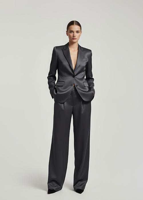Dark gray satin pantsuit featuring a tailored single-breasted blazer and fluid wide-leg trousers.
