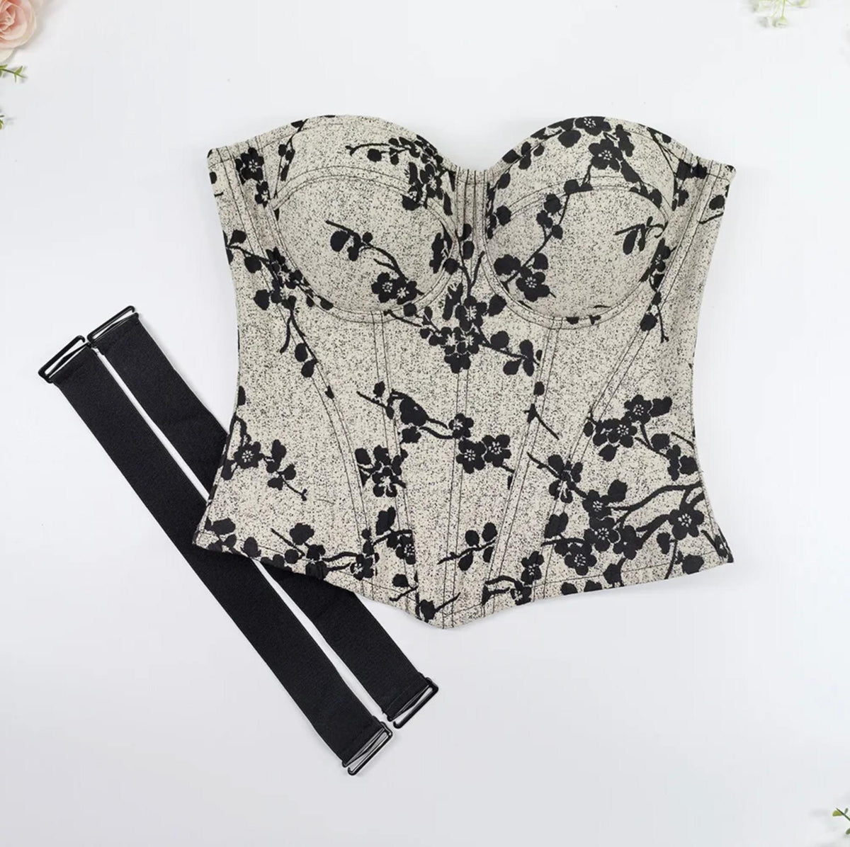 Beige and black floral print over-bust corset with structured cups, steel boning, and detachable black shoulder straps.