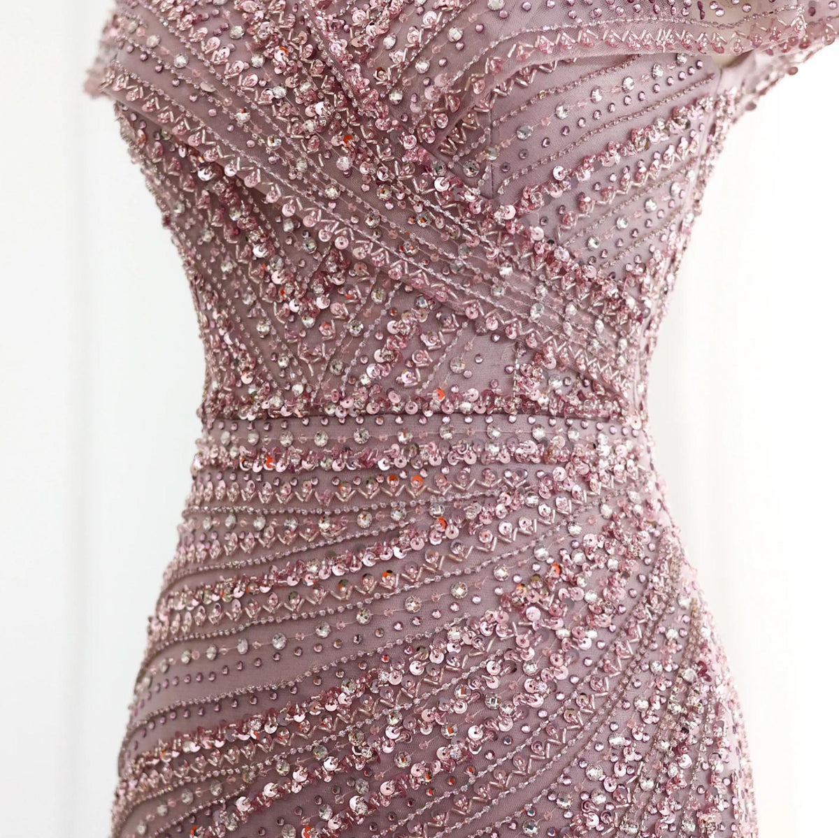 Silver nude mermaid gown featuring intricate crystal, sequin, and beaded geometric patterns on smooth Tencel fabric.