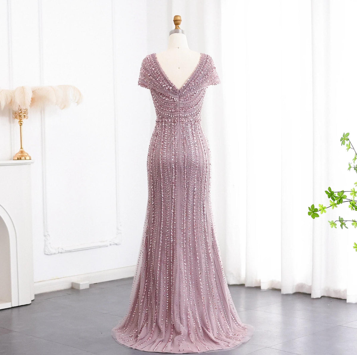 Silver nude mermaid gown with intricate crystal and sequin beadwork, featuring a V-neck and elegant sweeping train.