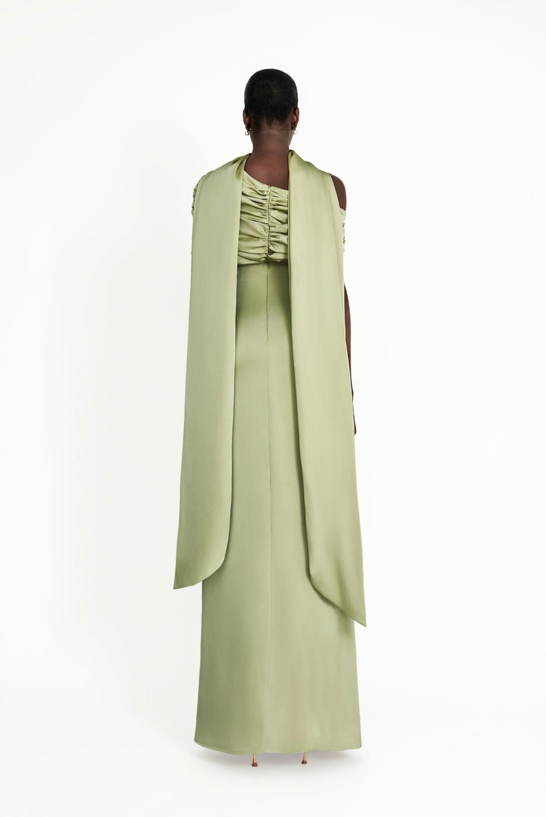 Sage green satin Kulture dress featuring a gathered Bardot neckline and flowing A-line silhouette from the back.