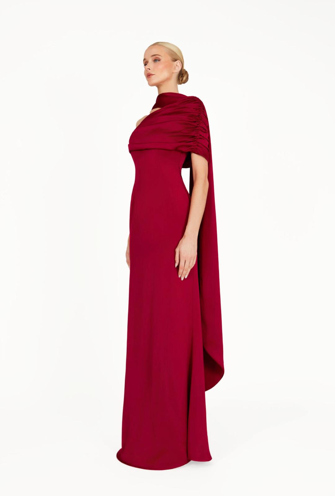 Elegant burgundy satin Kulture dress featuring a gathered Bardot neckline and a flowing, floor-length A-line silhouette.