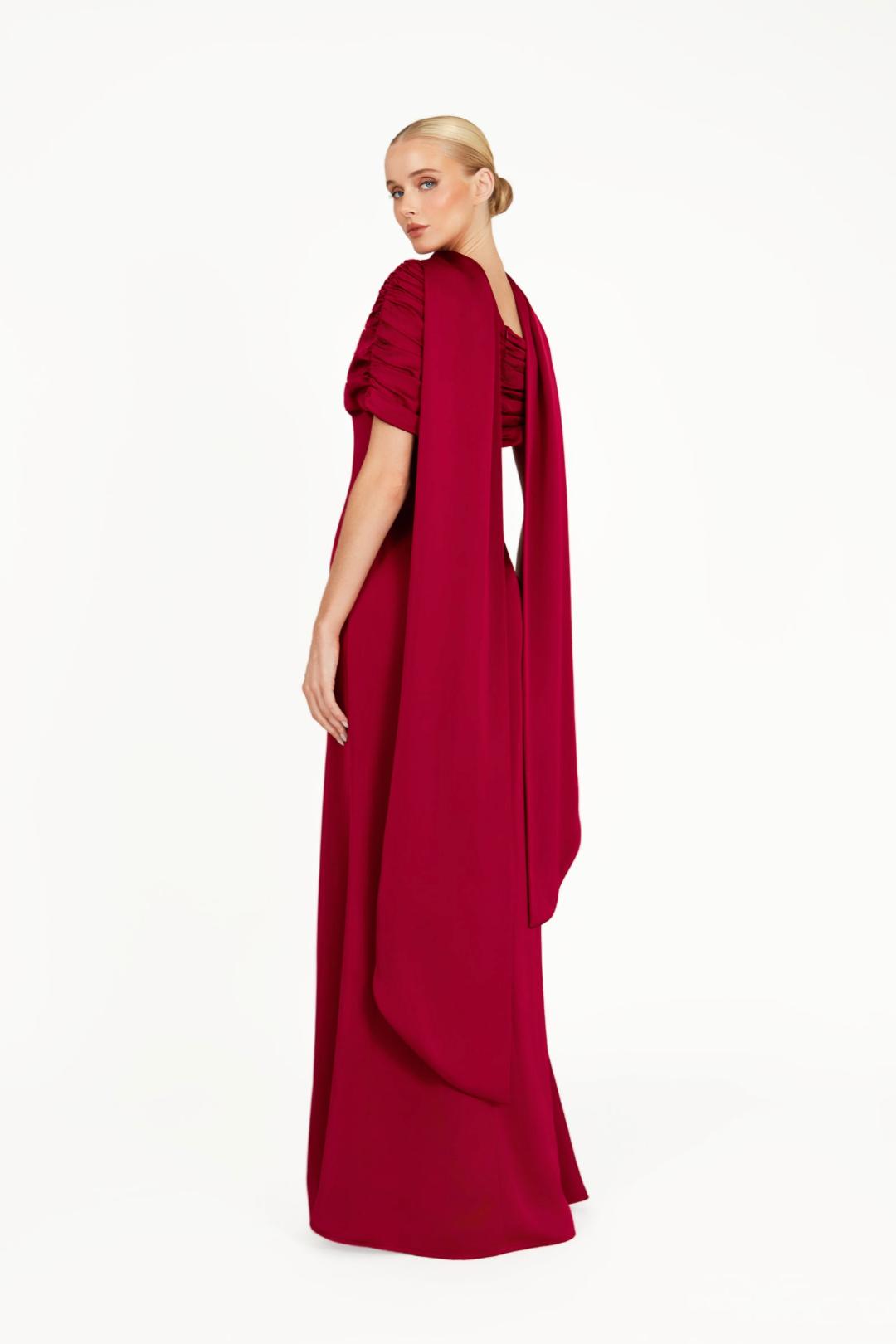 Elegant deep red satin Kulture dress with a gathered Bardot neckline and flowing A-line silhouette.