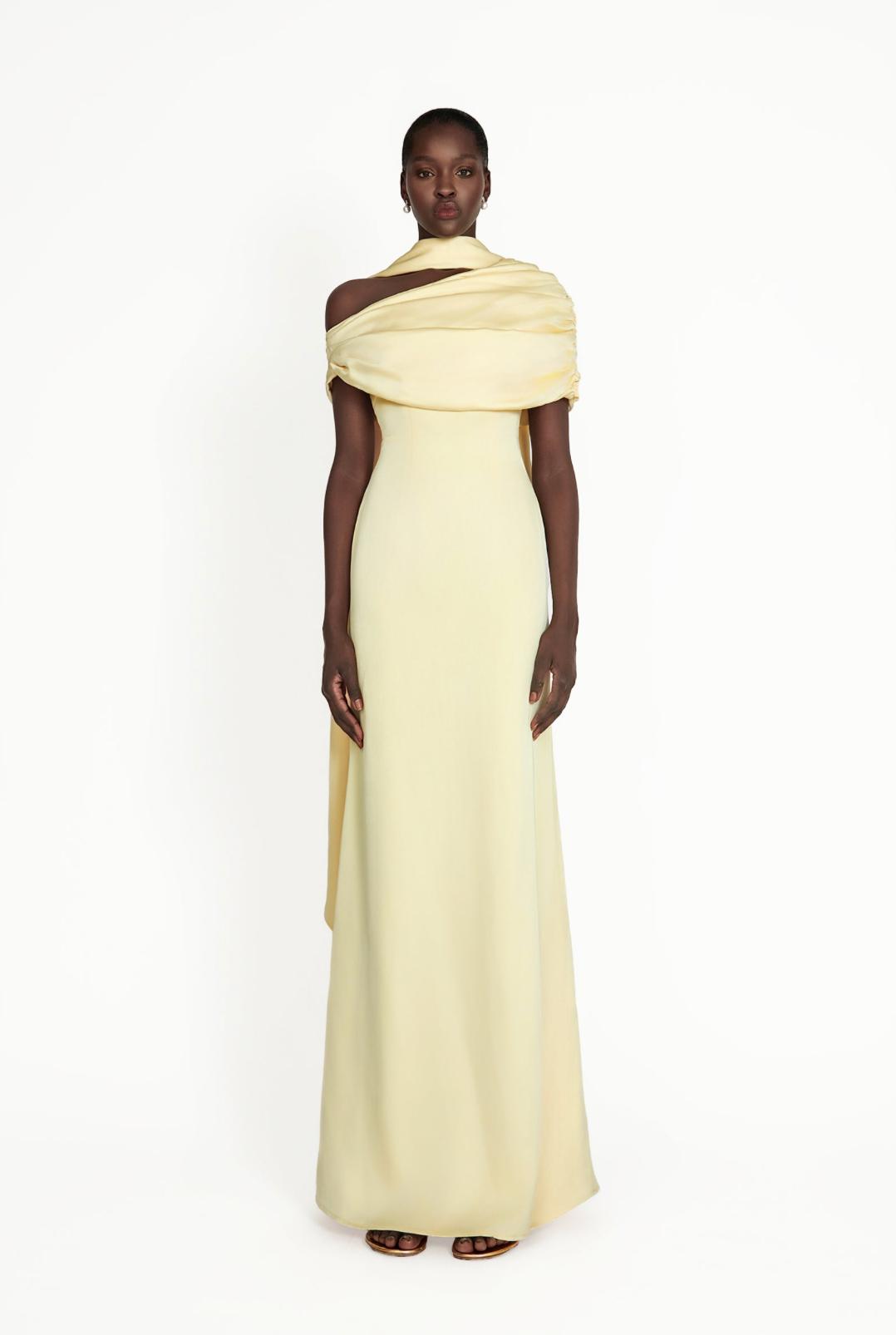 Pale yellow satin Kulture dress with a gathered Bardot neckline and flowing A-line silhouette on a model.