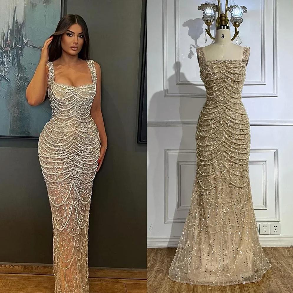 Nude floor-length sheath gown with a scoop neckline, adorned with intricate pearl and bead draping in a sleeveless design.