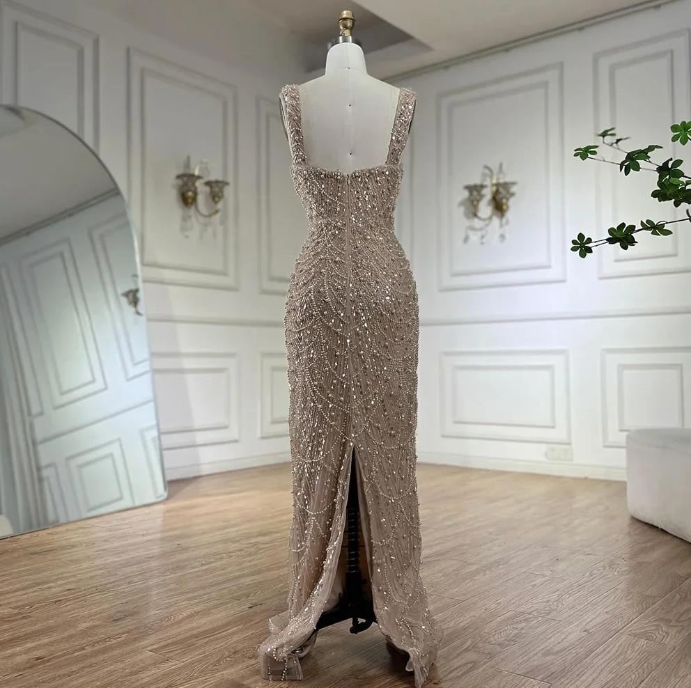 Nude floor-length sheath gown with intricate pearl and bead embellishments, scoop neckline, and back slit on a mannequin.