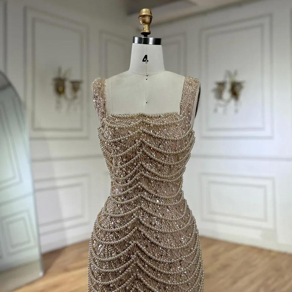 Nude floor-length sheath gown with a scoop neckline, adorned with intricate pearl and bead draping on a mannequin.