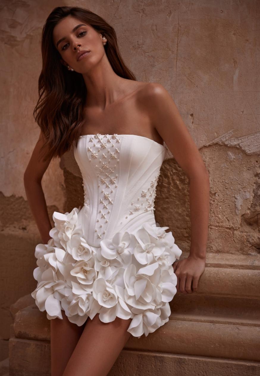 Strapless white bridal mini dress with 3D floral appliqués, pearl embellishments, and a structured corset bodice.