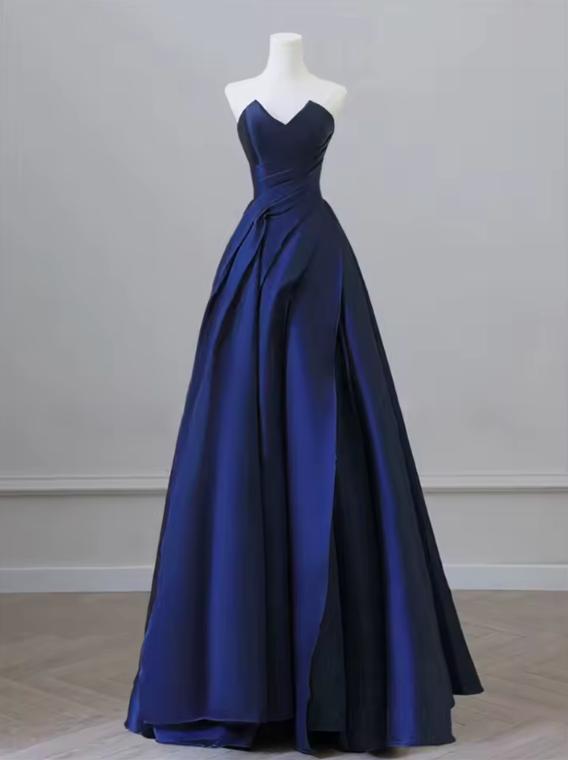 Elegant navy blue satin A-line gown with a sweetheart neckline and draped bodice on a mannequin.