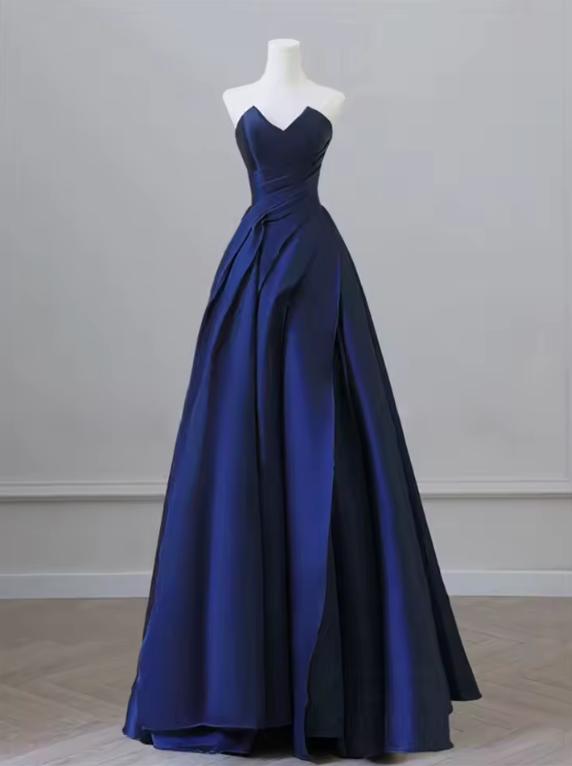 Elegant navy blue satin A-line gown with a sweetheart neckline and draped bodice on a mannequin.
