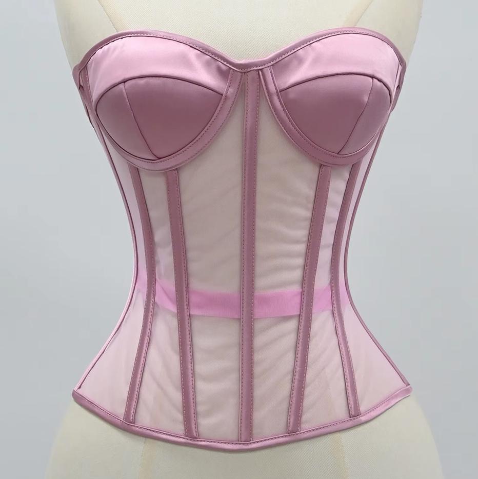The Lilah pink satin and mesh corset bustier displayed on a cream-colored dress form mannequin against a neutral light gray background.